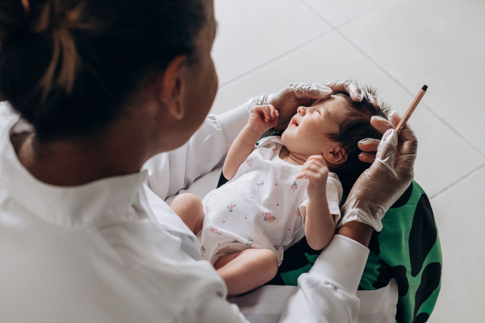 Médica examinando um recém-nascido durante consulta